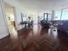 Herringbone wood-finish flooring, floor-to-ceiling windows, and decorative crown molding