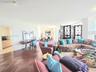 Herringbone-patterned wood-finish flooring, crown molding, floor-to-ceiling windows, and recessed ceiling lighting