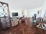 Herringbone-patterned wood-finish flooring, decorative metal room divider, and double-door entry