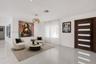 Interior entrance area featuring polished tile flooring, recessed lighting, a modern pendant light fixture, and a solid wood-finish entry door with ho