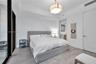 Neutral-toned wood-finish flooring, recessed ceiling lighting, contemporary drum chandelier, and solid-core interior doors