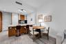 Kitchen featuring a stone-finish countertop, wood-finish cabinetry, built-in light fixtures, and wood-finish flooring throughout the space