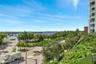 Elevated balcony featuring glass railings, unobstructed waterfront exposure, and expansive coastal landscape