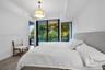 Floor-to-ceiling glass sliding doors, wood-finish flooring, recessed lighting, and a modern drum-style pendant light fixture