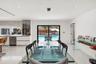 Open-concept interior featuring large-format tile flooring, recessed lighting, and sliding glass doors leading to a pool