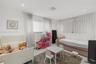 Interior space featuring large windows with floor-to-ceiling drapery, neutral wall finishes, recessed lighting, and tile flooring