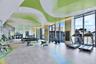 Expansive fitness area featuring floor-to-ceiling windows, large-format tile flooring, recessed lighting, and a custom patterned ceiling treatment