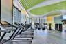 Fitness facility featuring floor-to-ceiling windows, large-format tile flooring, a custom curvilinear acoustic ceiling design, and integrated recessed