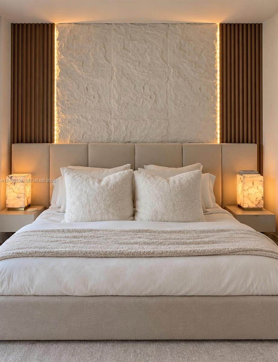 Textured stone accent wall featuring vertical wood-slat detailing, integrated perimeter lighting, and dual wall-mounted floating bedside fixtures