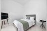 High-ceilinged room featuring neutral white walls and polished porcelain flooring