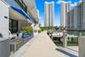 Waterfront terrace featuring composite decking, an retractable fabric awning, and direct access to a private boat dock