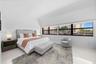 Spacious interior with high vaulted ceilings, large expansive window configuration, and polished tile flooring