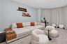 Curved wall featuring floor-to-ceiling drapery and wall-to-wall carpeting