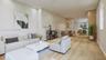 Open-concept interior featuring wood-finish flooring, recessed lighting, and wood-paneled cabinetry
