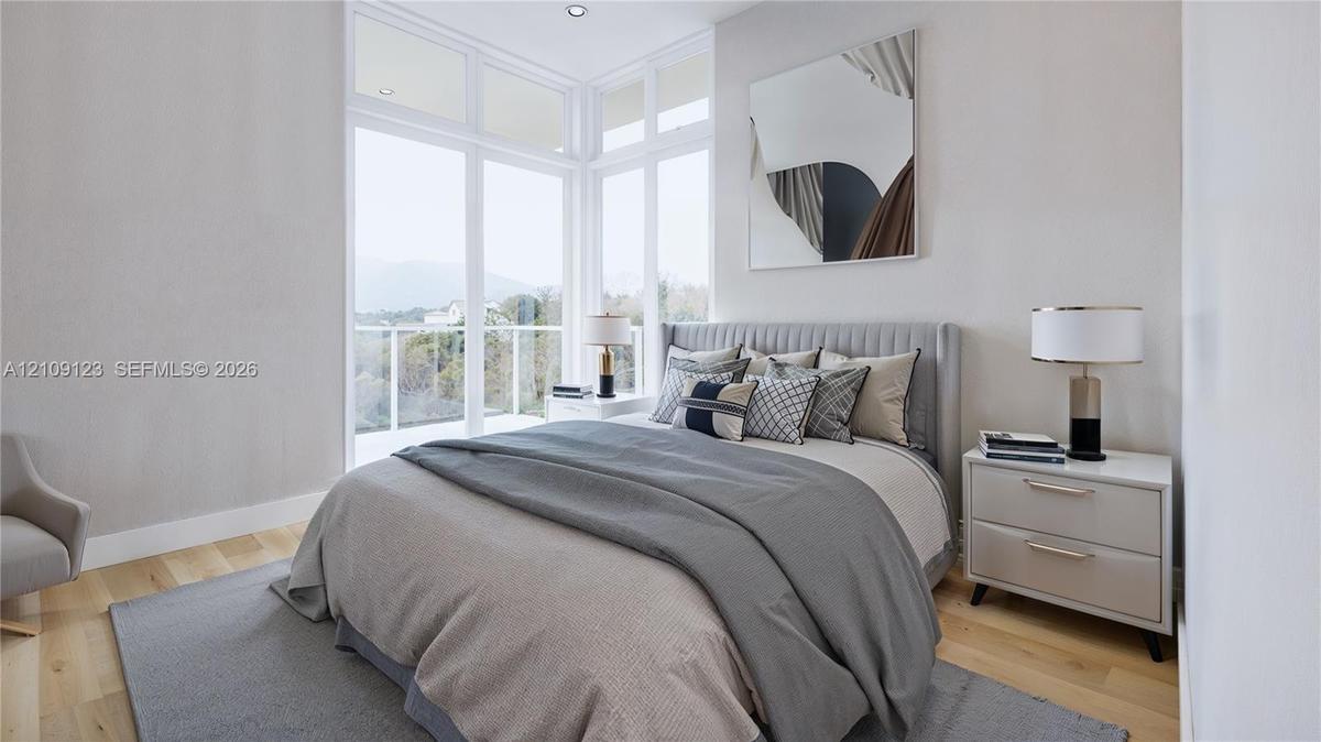 Floor-to-ceiling corner windows, wood-finish flooring, and recessed ceiling lighting