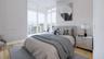 Floor-to-ceiling corner windows, wood-finish flooring, and recessed ceiling lighting
