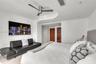 Curved architectural ceiling detail, dark-finish ceiling fan, recessed lighting, and solid-core wooden doors