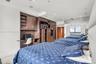 Custom built-in cabinetry with integrated desk station, recessed ceiling lighting, and large window