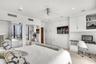 Built-in floor-to-ceiling cabinetry, recessed lighting, integrated desk workspace, mirrored closet doors, and flush-mount ceiling fan