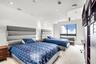 Room featuring a recessed ceiling detail, ceiling-mounted light fixtures, wall-to-wall carpeting, and a large window