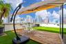 Rooftop terrace featuring synthetic turf, wood-finish decking, and low-profile perimeter walls
