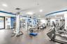 Fitness center featuring recessed lighting, rubberized flooring, and an assortment of strength training and cardiovascular equipment