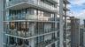 High-rise exterior featuring floor-to-ceiling glass windows and multiple cantilevered private balconies with frameless glass railings
