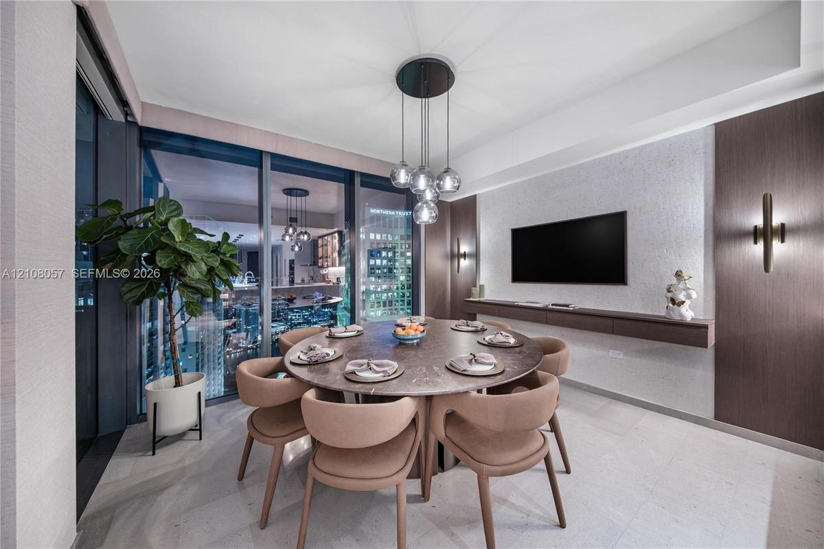 Floor-to-ceiling glass wall, recessed lighting, stone flooring, built-in floating shelf, and custom wall-mounted sconces
