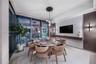 Floor-to-ceiling glass wall, recessed lighting, stone flooring, built-in floating shelf, and custom wall-mounted sconces
