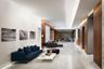 Spacious interior featuring stone flooring, wood-paneled walls, recessed ceiling lighting, and smooth-finish white walls