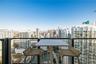Private balcony featuring a black metal railing, overlooking an expansive metropolitan skyline and river