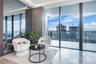 Floor-to-ceiling glass walls, expansive private balcony, polished stone flooring, recessed ceiling lighting, and full-height mirrored wall panel