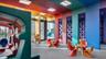 Multi-purpose interior space featuring oversized geometric wall paneling, high ceilings with recessed lighting, floor-to-ceiling glass windows, and du