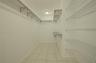 Walk-in storage space featuring ceramic tile flooring, multi-level wire shelving, and a centralized ceiling-mounted light fixture