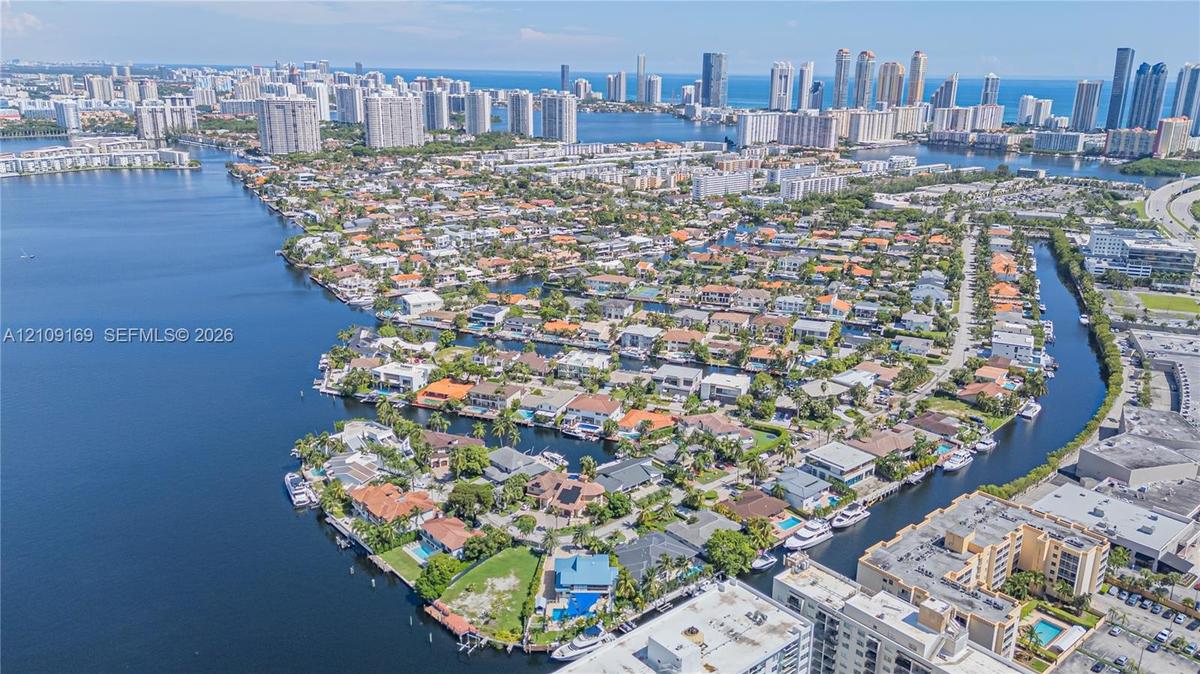Aerial perspective of a waterfront residential enclave featuring navigable canal access, deep-water bulkhead frontage, and proximity to the coastal sh