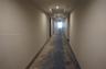 Hallway featuring patterned carpet flooring, recessed ceiling lighting, and neutral-toned walls