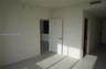 Neutral-toned tile flooring, solid-core interior doors with satin nickel hardware, and recessed ceiling HVAC registers