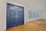 Double entry doors featuring leaded glass fanlights, recessed ceiling lighting, wood-finish flooring, and white plantation shutters