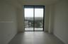 Large-format tile flooring, black-framed sliding glass doors, and a private balcony featuring metal railings and exterior tile flooring