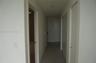 Interior hallway featuring neutral wall paint, recessed lighting, tile flooring, and multiple bifold closet doors
