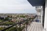 Elevated private balcony featuring metal railing, tiled flooring, and an overhang
