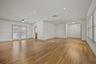 Wood-finish flooring, recessed lighting, ceiling fan, crown molding, and plantation shutters