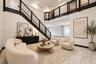 Grand entryway featuring a double-height ceiling, dramatic staircase with dark-finished wood handrails, and horizontal cable railing system