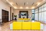 Common area featuring a tray ceiling, recessed lighting, wood-finish flooring, floor-to-ceiling windows, and built-in shelving