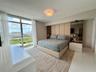 Floor-to-ceiling windows, polished stone flooring, integrated mirrored wall panels, and flush-mount lighting