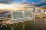 Waterfront high-rise building featuring extensive glass balconies, integrated boat slips, and deep-water access