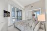 Floor-to-ceiling glass windows, recessed ceiling lighting, sliding glass door, and mirrored closet doors