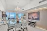 Expansive floor-to-ceiling glass windows, custom wood-paneled feature wall with integrated accent lighting, polished tile flooring, and decorative cry
