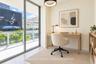 Floor-to-ceiling sliding glass door, private balcony with metal railing, neutral tile flooring, and circular modern pendant light fixture