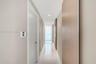 Hallway featuring large-format tile flooring, recessed lighting, and light wood-tone door finishes